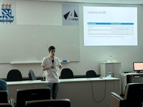 Foto com o discente apresentando trabalho em evento 